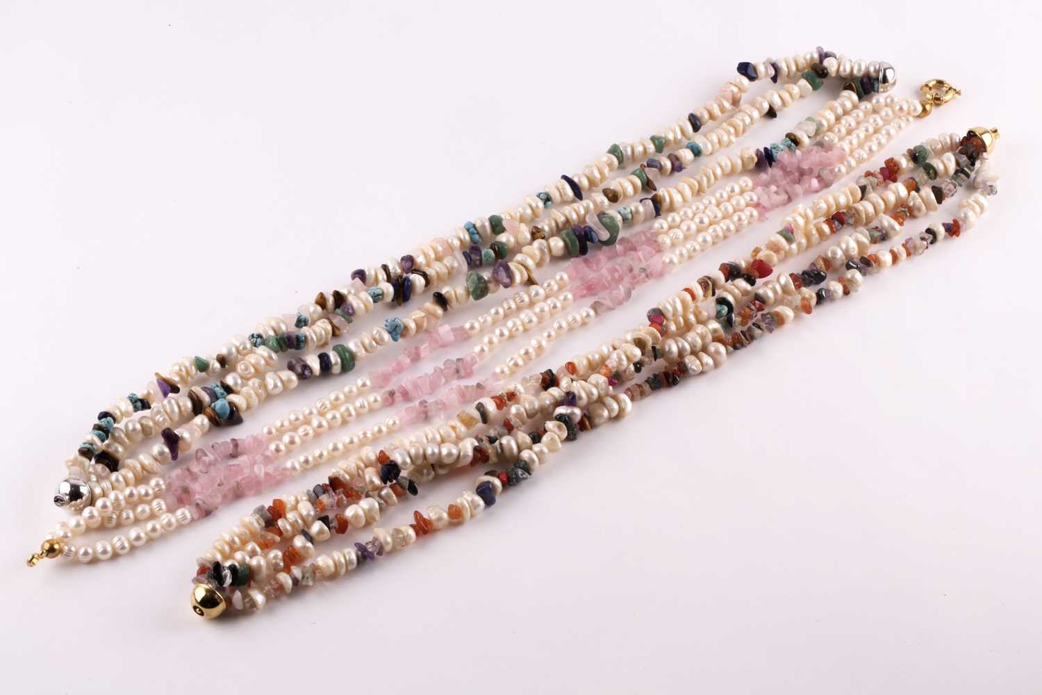 Lot 185 - A three-strand freshwater pearl and rose...