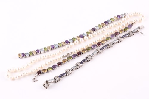Lot 281 - A multi gem-set bracelet, composed of oval cut...