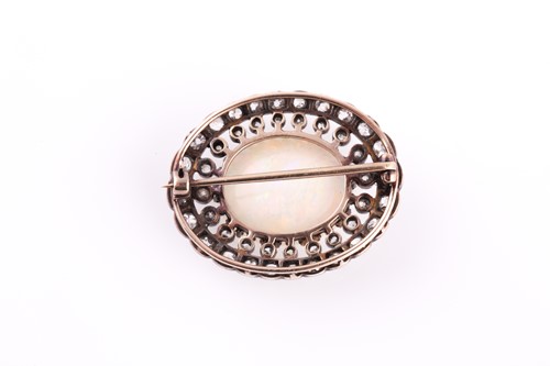 Lot 325 - A diamond and opal brooch, of oval design,...