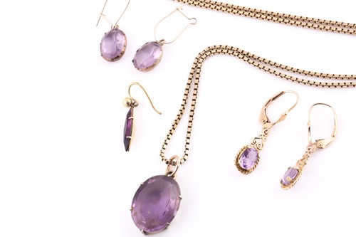 Lot 440 - A yellow metal and amethyst pendant, suspended...