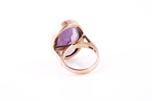 Lot 101 - A 9ct yellow gold and amethst dress ring, set...