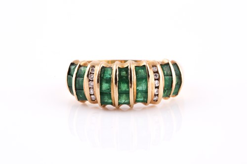 Lot 116 - An 18ct yellow gold, diamond, and emerald ring,...