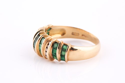 Lot 116 - An 18ct yellow gold, diamond, and emerald ring,...
