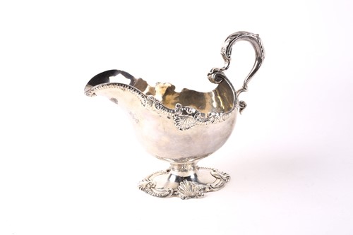 Lot 551 - A Victorian heavy silver pedestal gravy jug....