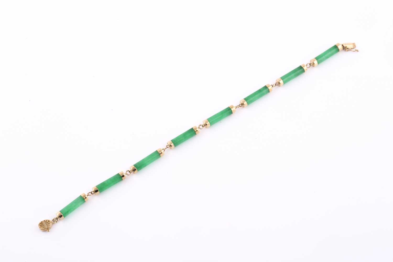 Lot 62 - A 14ct yellow gold and jade bracelet, the...