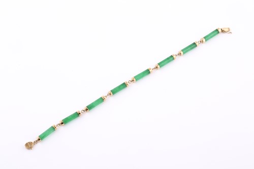 Lot 62 - A 14ct yellow gold and jade bracelet, the...