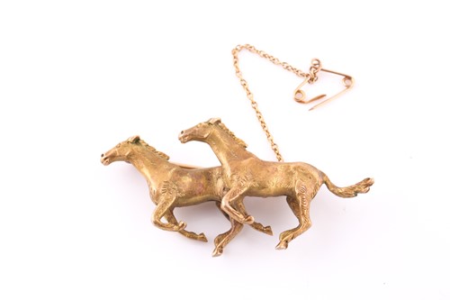 Lot 624 - A gold brooch Depicting two galloping horses...