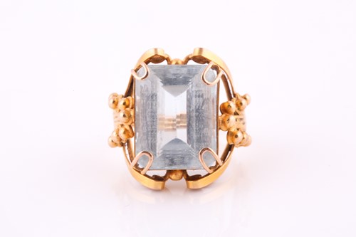 Lot 704 - A single stone aquamarine dress ring; the step...