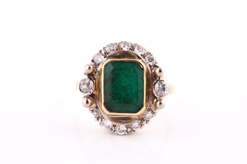 Lot 560 - An emerald and diamond cluster; the...