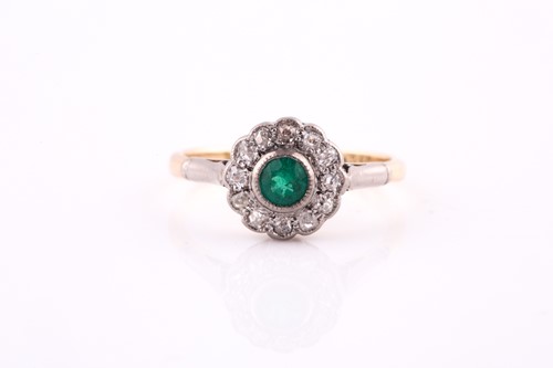 Lot 647 - An emerald and diamond cluster ring; the...