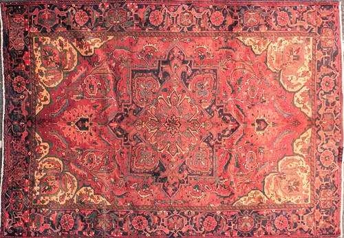 Lot 207 - A 20th-century red ground Heriz carpet. With a...