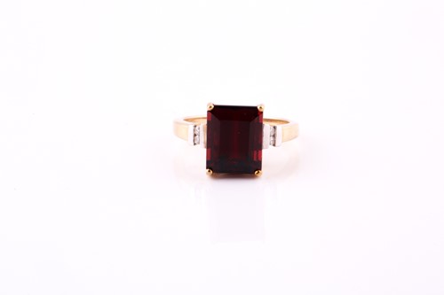 Lot 480 - A ruby and diamond ring the step-cut ruby,...