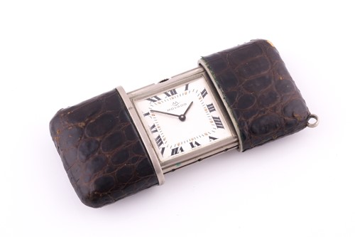 Lot 713 - A purse watch by Movado The brown leather...