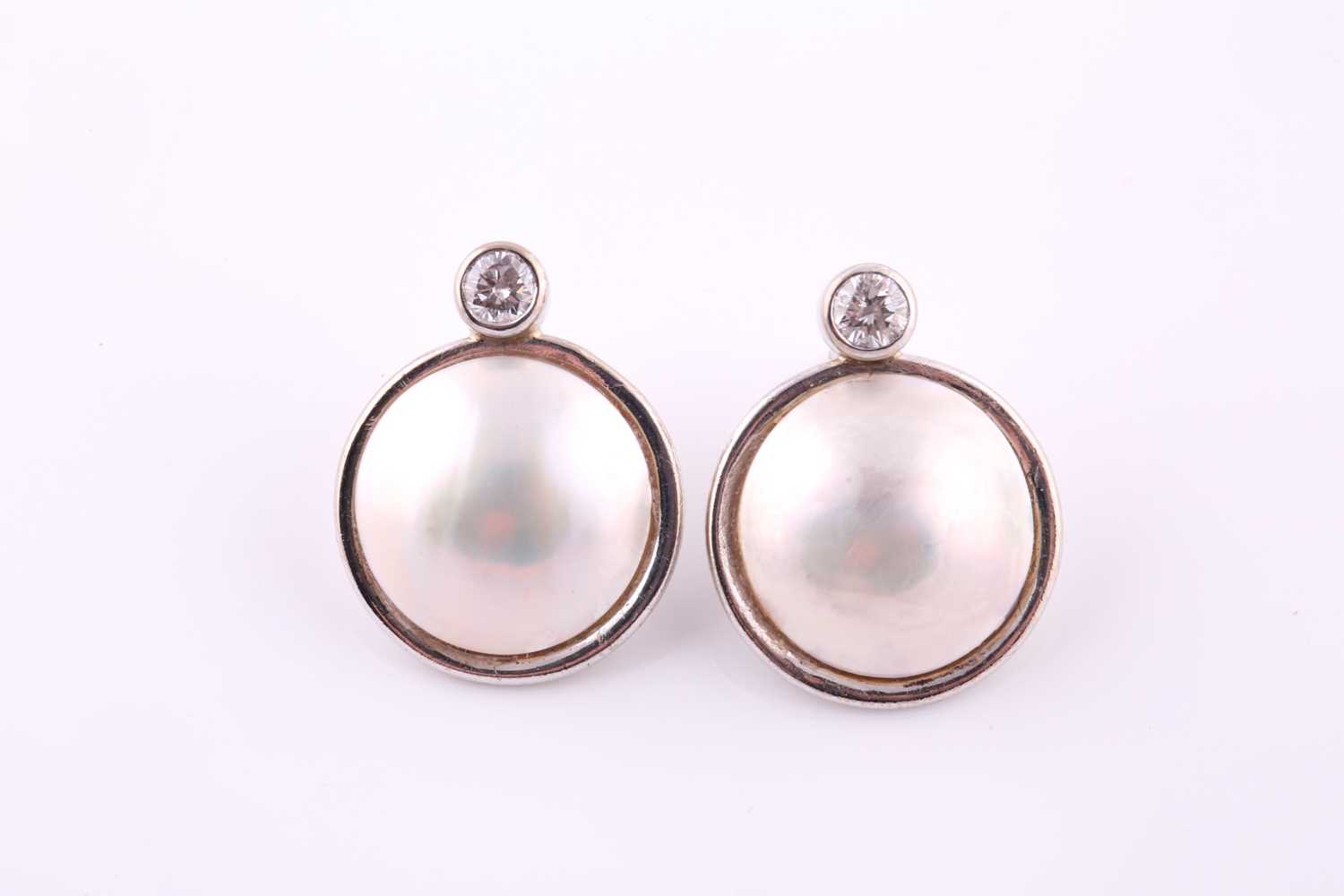 Lot 30 - A pair of mabe pearl and diamond earrings Each...