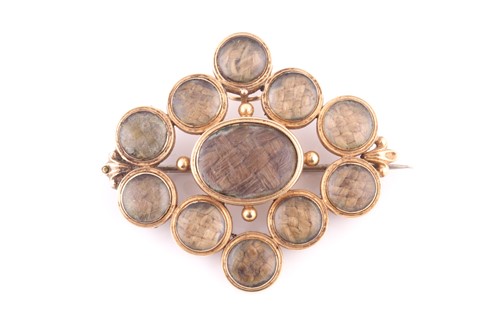 Lot 457 - A mourning brooch The central oval-shaped...