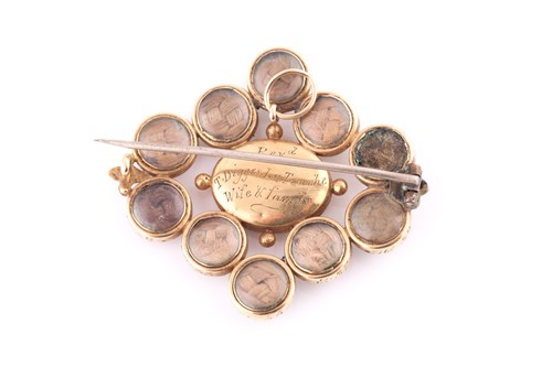 Lot 457 - A mourning brooch The central oval-shaped...