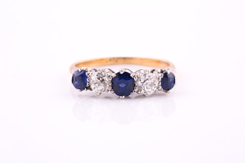 Lot 528 - A five stone half hoop sapphire and diamond...