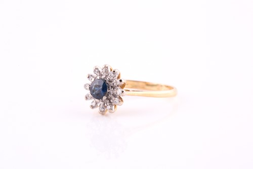 Lot 337 - A sapphire and diamond cluster ring, the round...