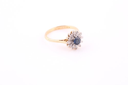 Lot 337 - A sapphire and diamond cluster ring, the round...