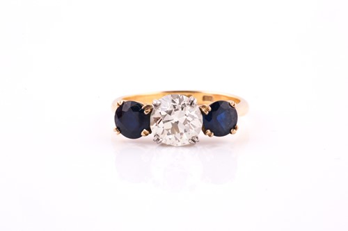Lot 669 - A sapphire and diamond three-stone ring The...