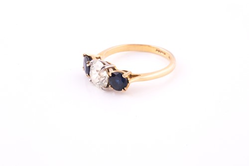 Lot 669 - A sapphire and diamond three-stone ring The...