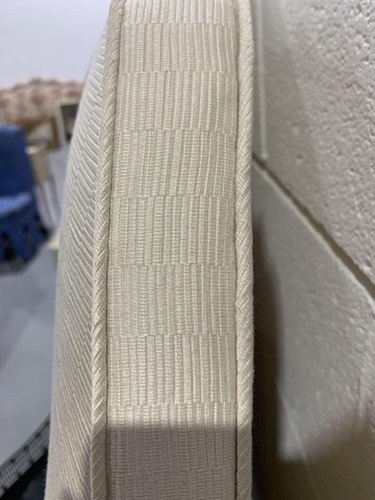Lot 100 - An emperor sized stepped arch cream padded...