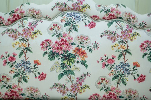 Lot 18 - A floral chintz upholstered serpentine topped...