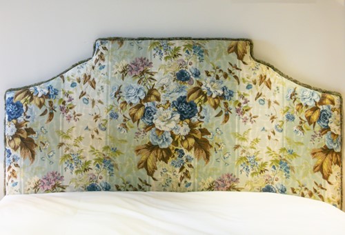 Lot 23 - A floral chintz upholstered crow stepped...