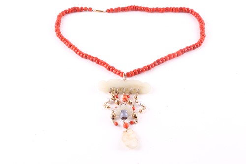 Lot 421 - A coral and jadeite pendant necklace the row...