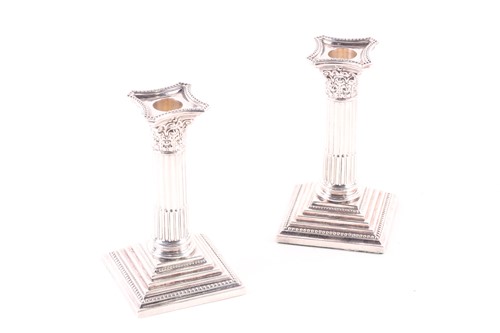 Lot 758 - A pair of Corinthian column candlesticks,...