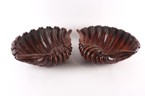 Lot 223 - A pair of carved wood clam shells, early 20th...