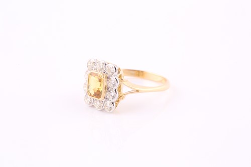 Lot 332 - A yellow sapphire and diamond cluster ring,...