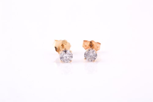 Lot 591 - Pair of diamond earrings, each set with a...