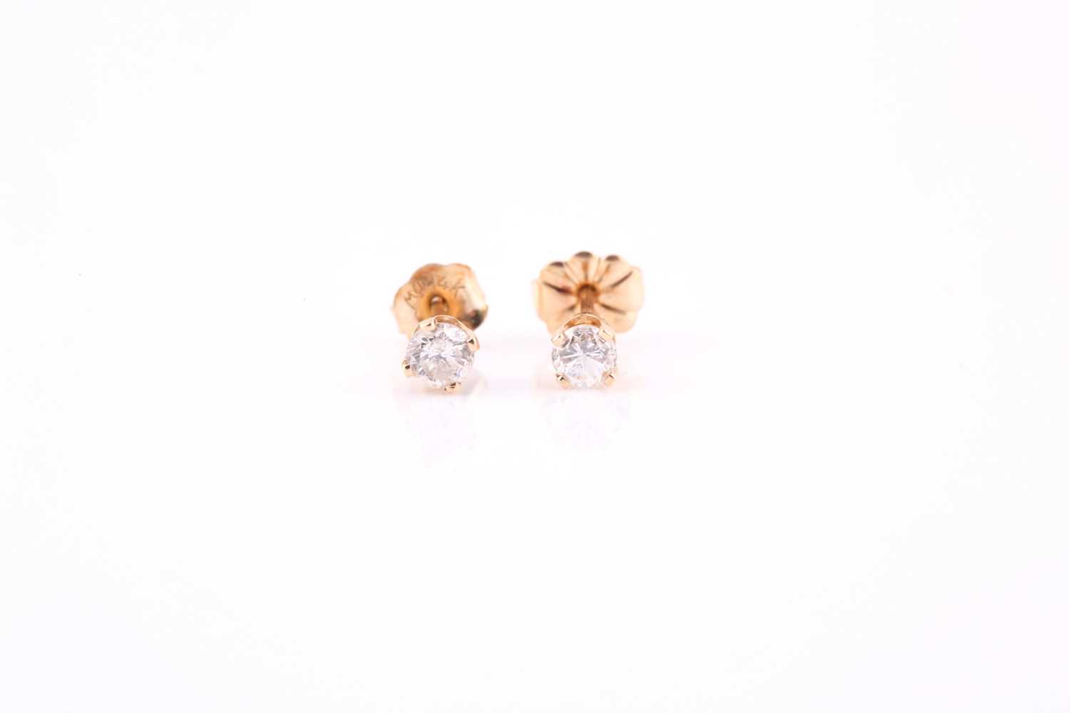 Lot 411 - Pair of diamond earrings, each with a round...