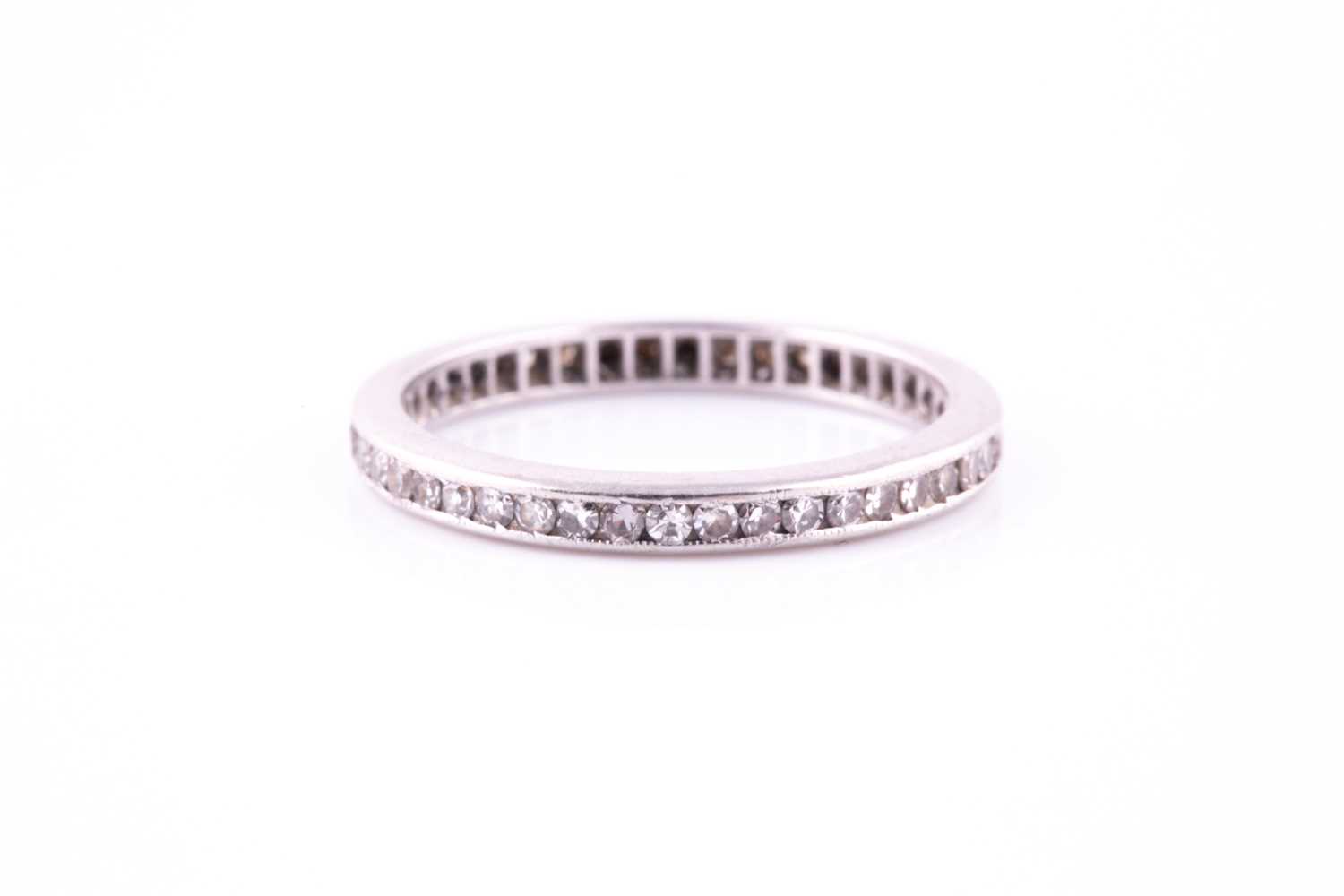 Lot 214 - A diamond full eternity ring, millegrain set...