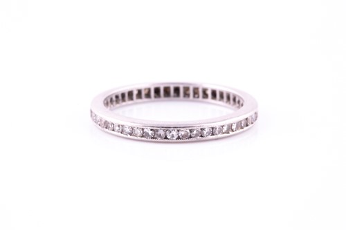 Lot 214 - A diamond full eternity ring, millegrain set...
