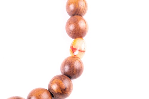 Lot 280 - A long Chanel necklace, the turned wooden...