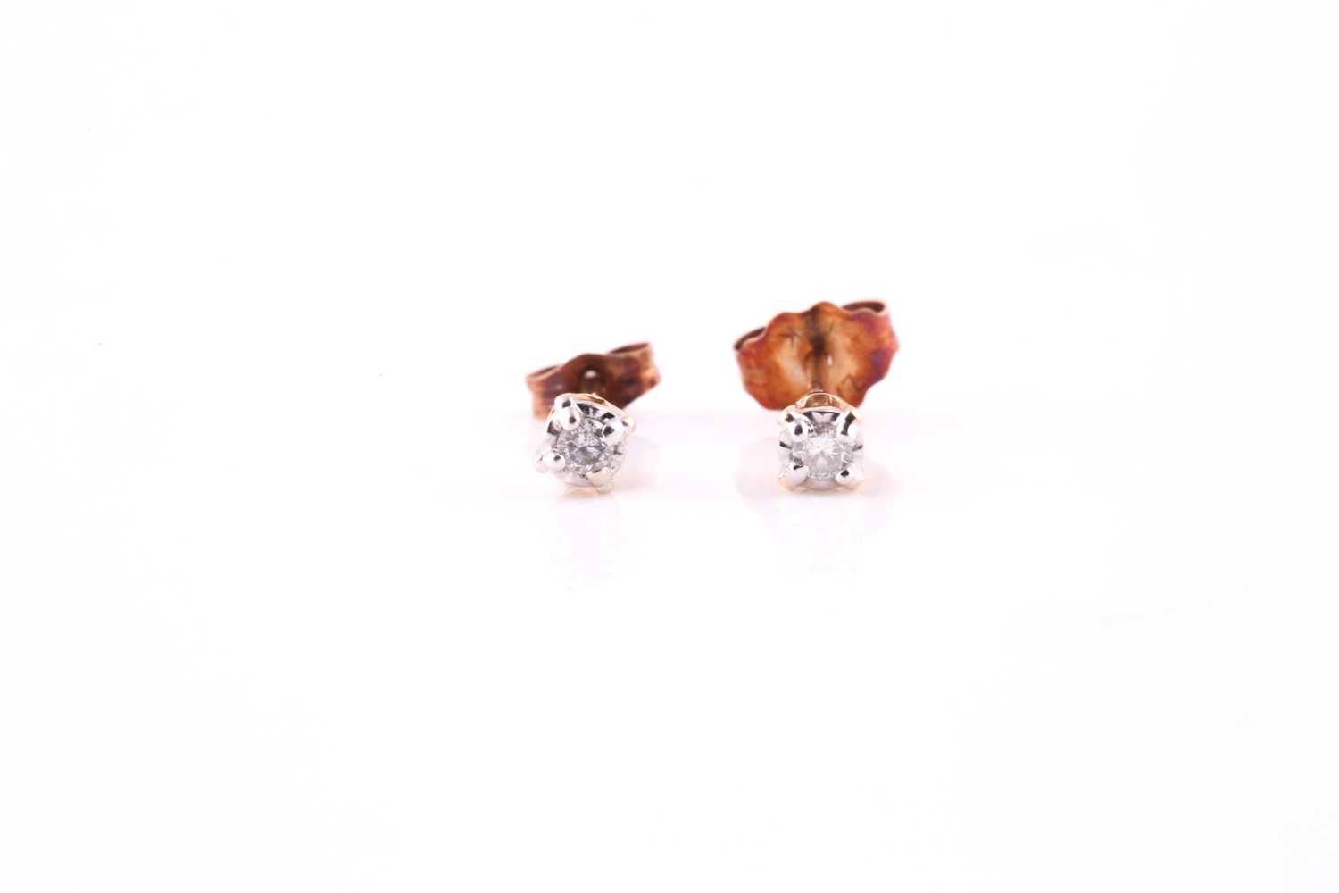 Lot 63 - A pair of diamond ear studs, each illusion set...