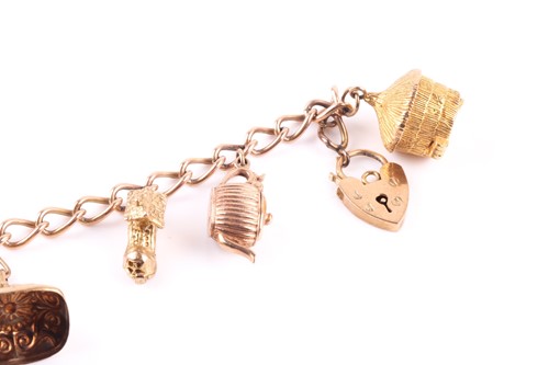 Lot 159 - A 9ct gold charm bracelet with charms,...