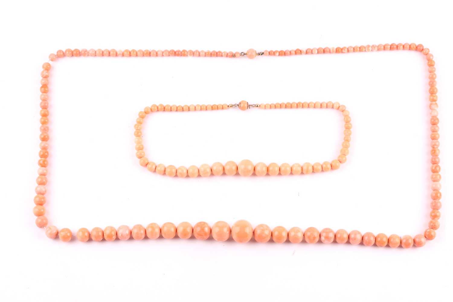 Lot 137 - Two early 20th century light-orange coral bead...