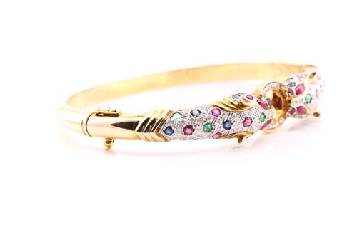 Lot 83 - A Cartier-style panther bangle, the panther...
