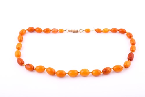 Lot 211 - An amber bead necklace consisting of...
