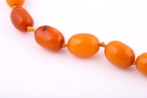 Lot 211 - An amber bead necklace consisting of...