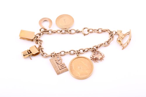 Lot 117 - A 9ct yellow gold charm bracelet with eight...