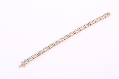 Lot 276 - An aquamarine and diamond tennis line bracelet,...