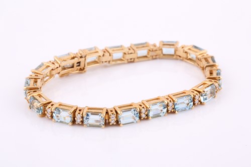 Lot 276 - An aquamarine and diamond tennis line bracelet,...
