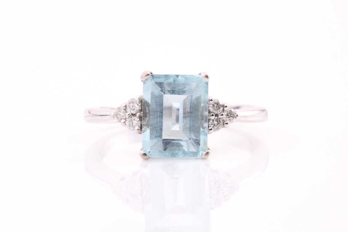 Lot 230 - An 18ct gold aquamarine and diamond ring, with...
