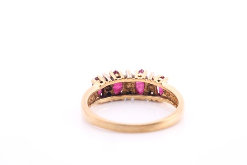 Lot 31 - An 18ct yellow gold, ruby and diamond eternity...