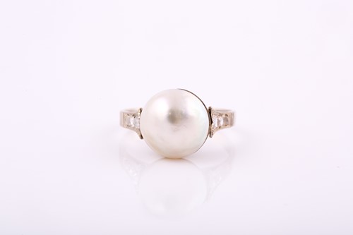 Lot 96 - A ring set with a central Mabe pearl with...