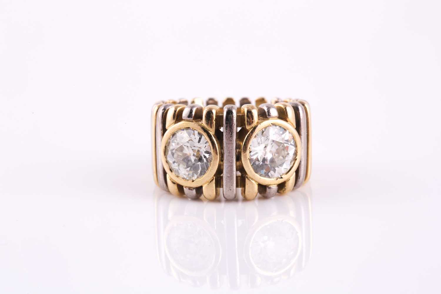 Lot 123 - A dual diamond dress ring, with two rub-over...